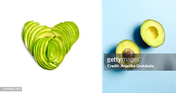 avocado. sliced avocado in the shape of a heart isolated on white background and avocado on blue background. - avocado slices fotografías e imágenes de stock