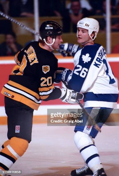 Mike Krushelnyski of the Toronto Maple Leafs skates against Bob Sweeney of the Boston Bruins during NHL game action on March 5, 1991 at Maple Leaf...