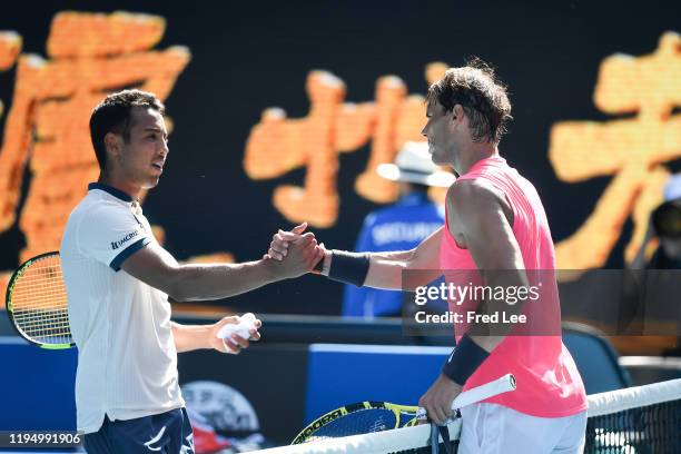 Rafael Nadal of Spain and Hugo Dellien of Bolivia embrace at the net following their Men's Singles first round match on day two of the 2020...
