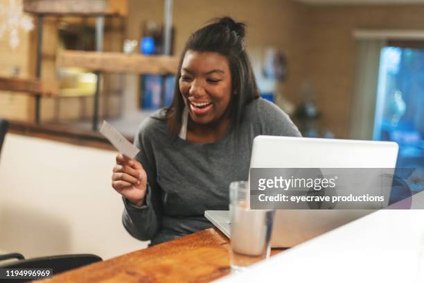 african american generation z female getting news on college funding at home - draft media opportunity stock pictures, royalty-free photos & images