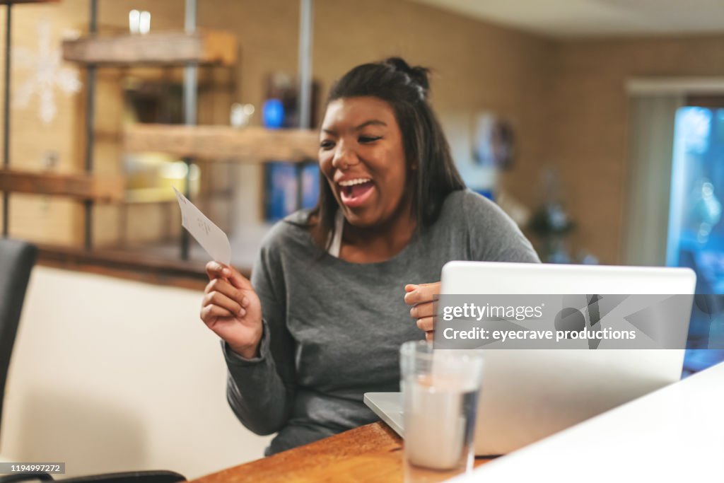 African American Generation Z Female Getting News on College Funding at Home