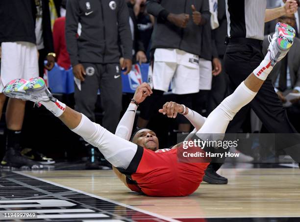 Russell Westbrook of the Houston Rockets celebrates his basket with a Paul George of the LA Clippers foul during a 122-117 Rockets win at Staples...