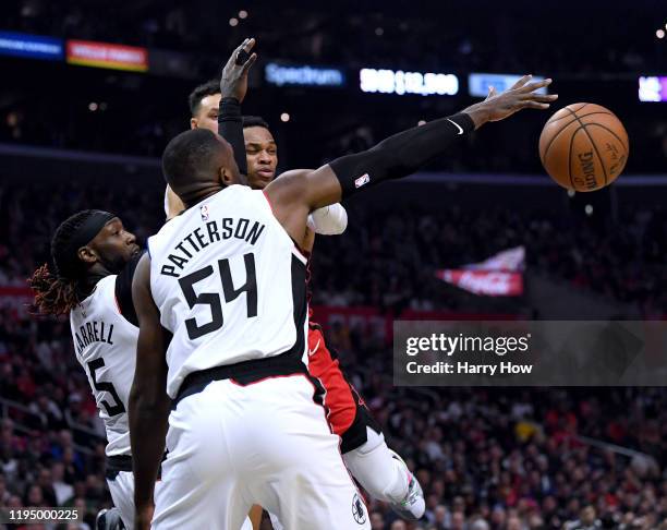 Russell Westbrook of the Houston Rockets passes out of a triple team from Patrick Patterson, Montrezl Harrell and Landry Shamet of the LA Clippers...