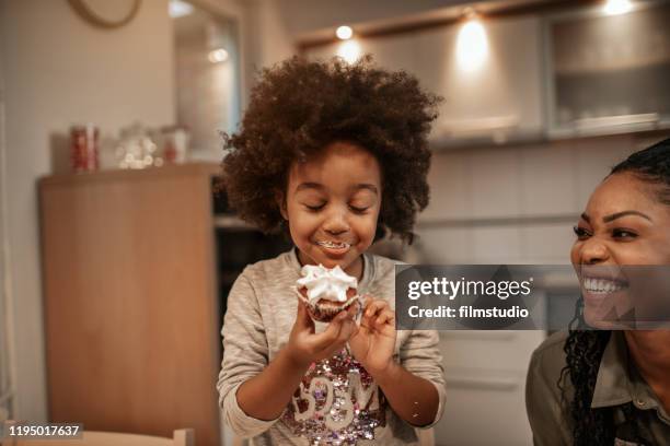 enjoying christmas sweets - cute girl hairstyles family stock pictures, royalty-free photos & images