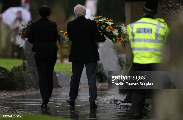 Floral tributes are carried into the church before a memorial service to celebrate the life of Saskia Jones at Holy Trinity Church on December 20,...