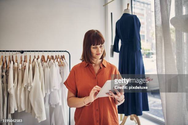 checking on orders that need to go out - clothing store imagens e fotografias de stock