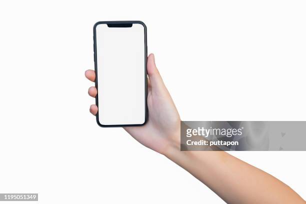 close up of woman hand holding smartphone on white background, cropped hand using smartphone on the background white - human hand stock pictures, royalty-free photos & images