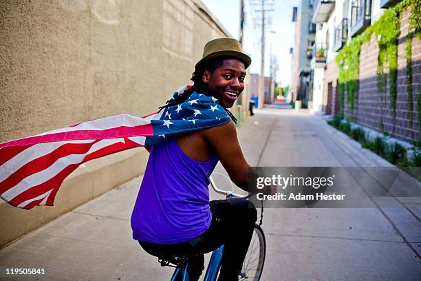 a young man with an american flag around his neck. - patriotic stock pictures, royalty-free photos & images