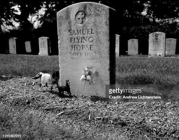 Tombstones of young Indians are decorated with small tokens of memory in August of 2010 at the old Carlisle Indian School Cemetery, now located on...