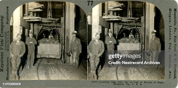 Stereo view by Keystone View Company depicting a group of miners working at the bottom of a mine shaft loading cage with car of coal in Scranton,...