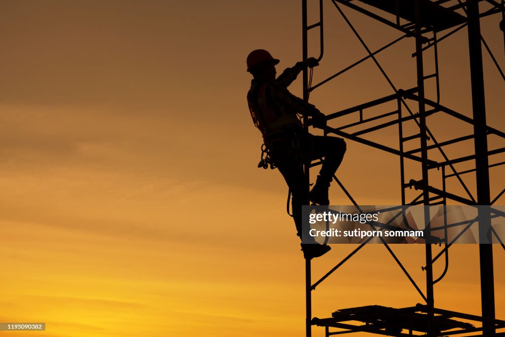 Engineers are climbing on the scaffolding in the construction site