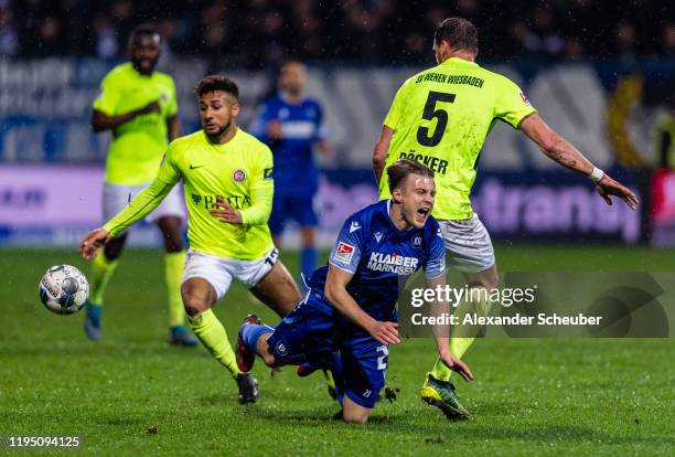 Benedikt Roecker of Wiesbaden in action against Marco Thiede of Karlsruhe during the Second Bundesliga match between Karlsruher SC and SV Wehen...