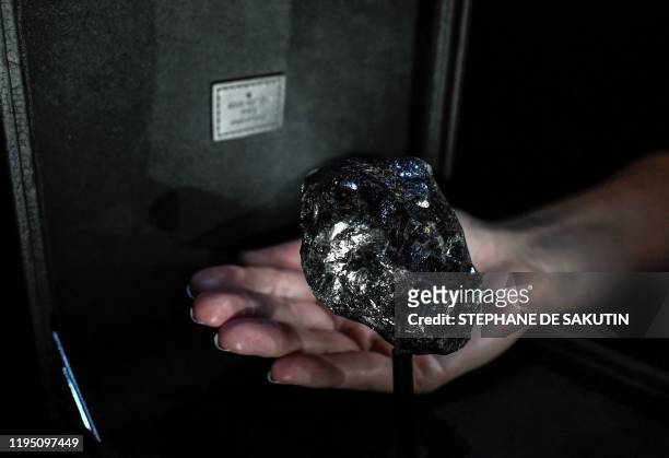 This picture taken on January 21 shows the second world biggest rough diamond named "Sewelo" displayed at place Vendome's Louis Vuitton luxury shop...