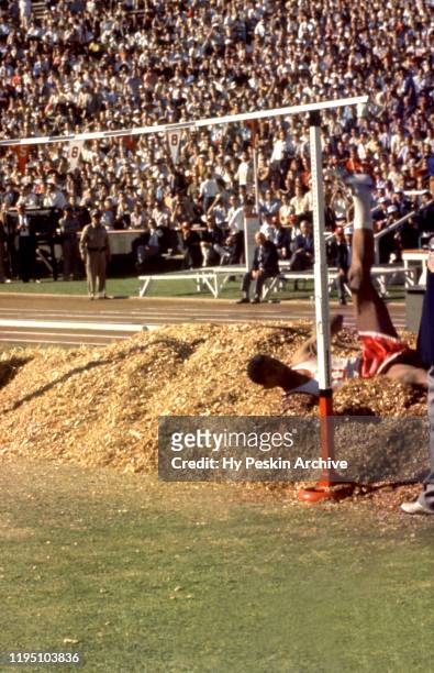 High jumper John Thomas of Boston University lands in the sawdust after his jump during the 1960 U.S. Olympic Track and Field Trials on July 1, 1960...