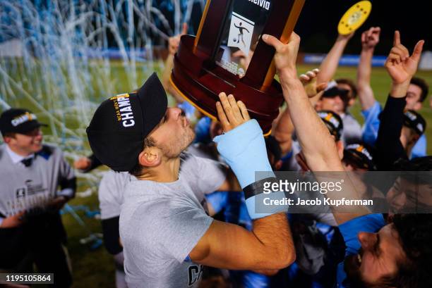 Joe Braun of the Tufts Jumbos celebrates with the trophy after defeating the Amherst Mammoths during the Division III Men's Soccer Championship held...