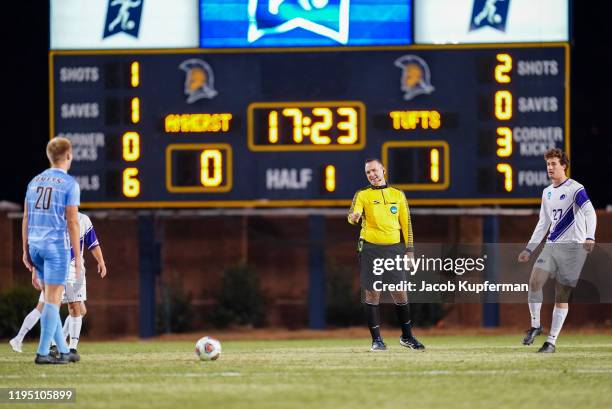 The referee talks to Calvin Aroh of Tufts Jumbos as he takes on the Amherst Mammoths during the Division III Men's Soccer Championship held at UNCG...