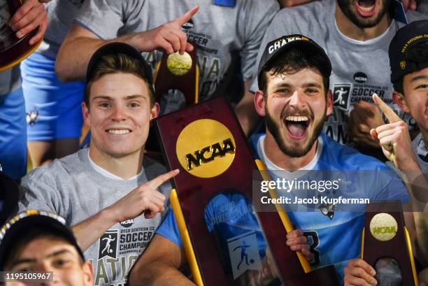 Tanner Jameson of Tufts Jumbos celebrates with the trophy after defeating the Amherst Mammoths during the Division III Men's Soccer Championship held...