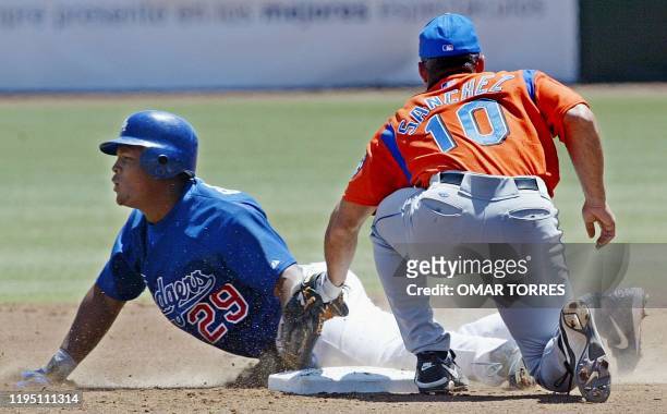 Baseball players Rey Sanchez of the New York Mets and Adrian Beltre of the LA Dodgers are seen in action in Mexico City 16 March 2003. Rey Sanchez,...