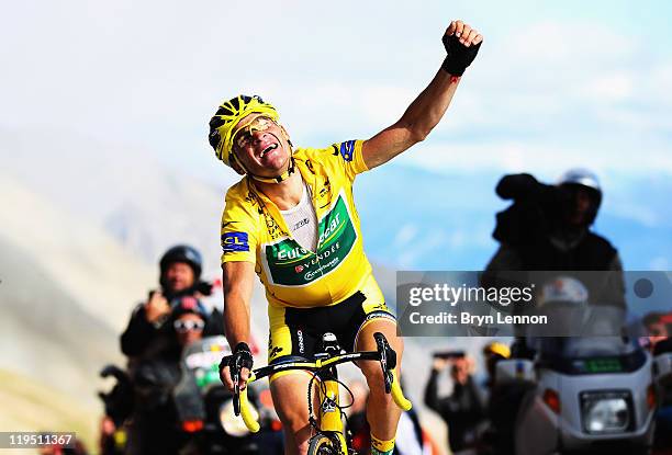Thomas Voeckler of France and Team Europcar celebrates as he retains the race leaders' yellow jersey by 15 seconds after stage eighteen of the 2011...
