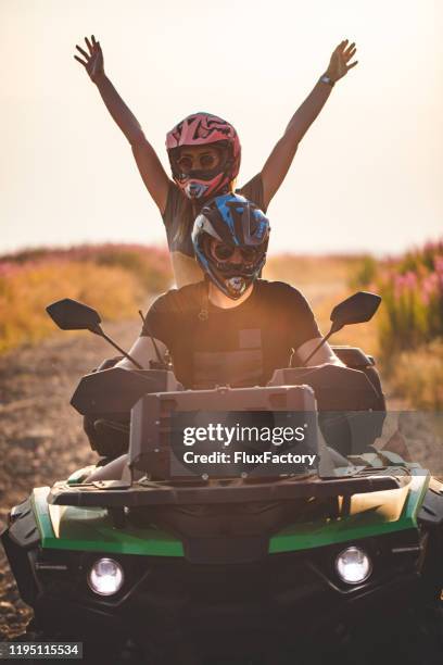 couple on holiday enjoying on a atv bike ride - atv riding stock pictures, royalty-free photos & images