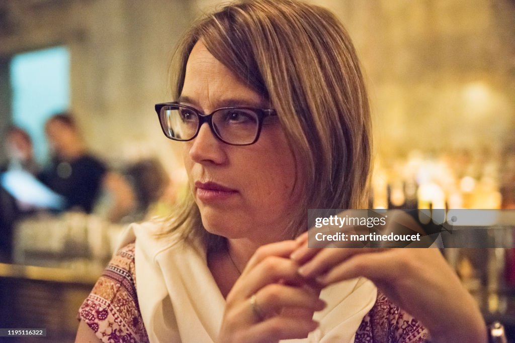 Portrait of mature woman having a drink in bar.