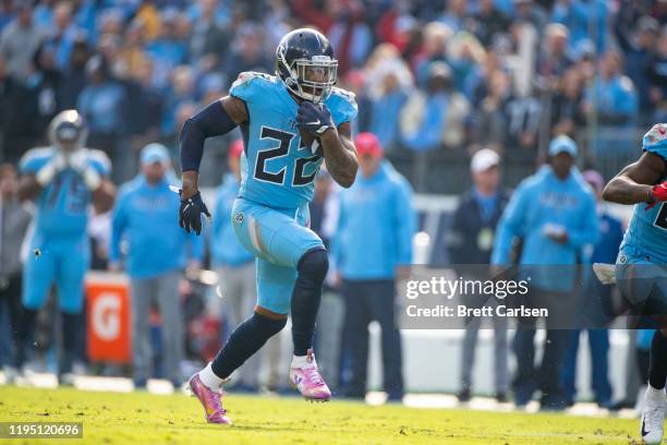 Derrick Henry of the Tennessee Titans carries the ball against the Houston Texans during the second quarter at Nissan Stadium on December 15, 2019 in...