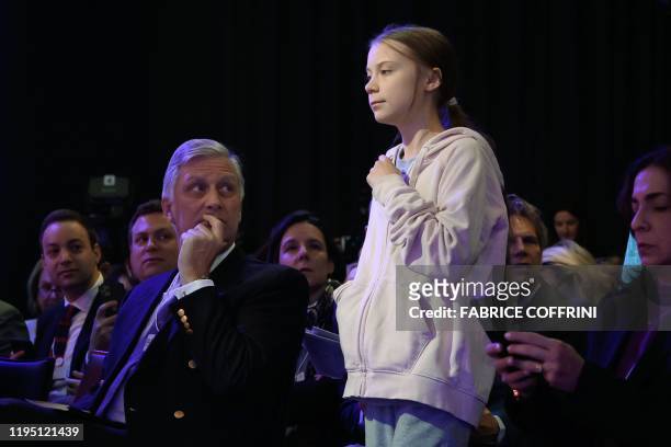 Swedish climate activist Greta Thunberg walks past King Philippe of Belgium prior to a session at the Congress center during the World Economic Forum...