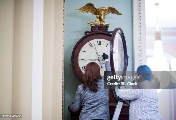 Capitol workers wind the Ohio Clock in the Ohio Clock Corridor in the Capitol on Tuesday, Jan. 21, 2020.