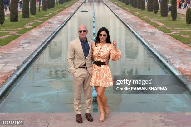 Chief Executive Officer of Amazon Jeff Bezos and his girlfriend Lauren Sanchez pose for a picture during their visit at the Taj Mahal in Agra on...