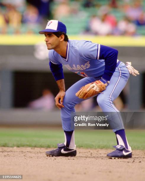 Damaso Garcia of the Toronto Blue Jays fields during an MLB game versus the Chicago White Sox during the 1986 season at Comiskey Park in Chicago,...