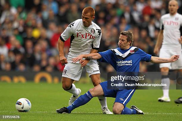 Steve Sidwell of Fulham is tackled by David Magowan of Crusaders during the UEFA Europa League 2nd Qualifying Round 2nd Leg match between Fulham and...