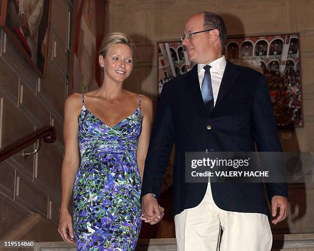 Prince Albert II of Monaco looks at his wife Princess Charlene of Monaco during their visit of the exhibition entitled "L'Histoire du Mariage...