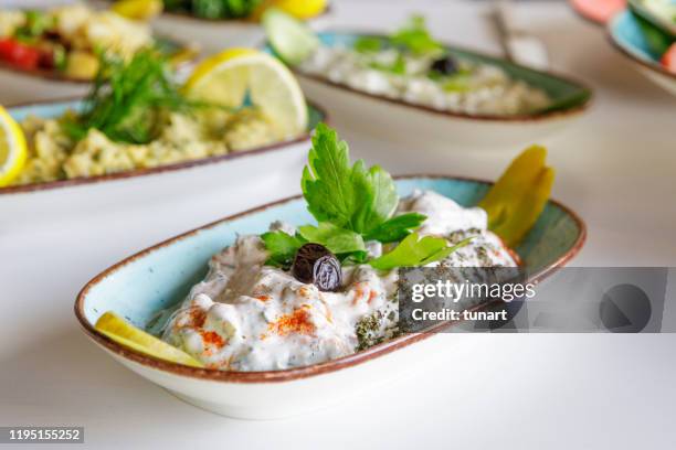 haydari meze with yoghurt on a dining table - greek culture stock pictures, royalty-free photos & images