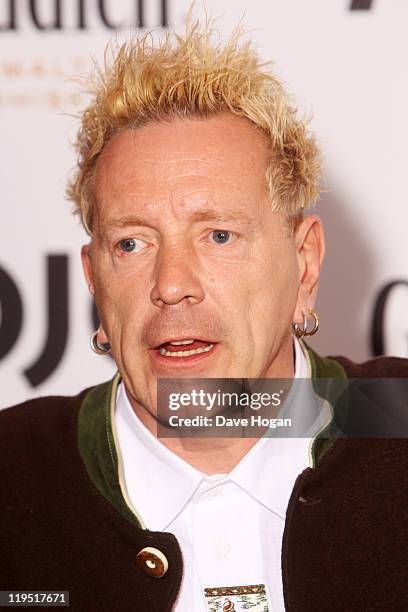 Johnny Rotton poses in front of the winners boards after accepting the Outstanding Contribution to Music Award for PiL at the Glenfiddich Mojo...