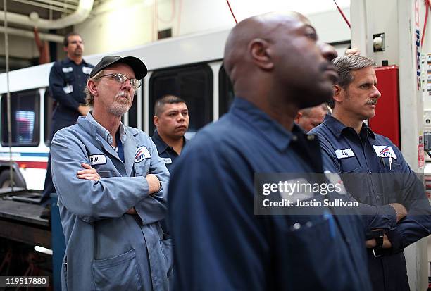 Santa Clara Valley Transportation Authority maintenance workers look on speaks following a tour of the hybrid technology training program on July 21,...