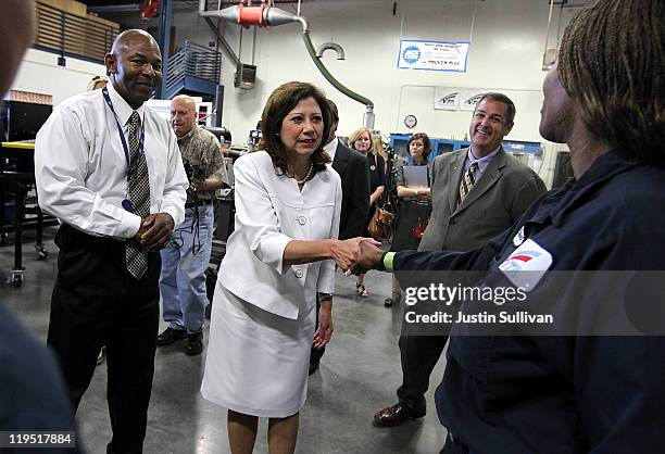 Secretary of Labor Hilda Solis greets a student with the Santa Clara Valley Transportation Authority hybrid technology training program as VTA...