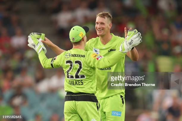 Chris Morris of the Thunder celebrates with team mates after claiming the wicket of Rashid Khan of the Strikers during the Big Bash League match...