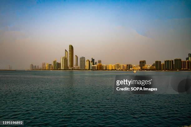 Abu Dhabi sky line and city scene shots from white sand beach on marina island.