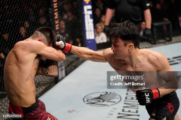 Dooho Choi of South Korea punches Charles Jourdain of Canada in their featherweight fight during the UFC Fight Night event at Sajik Arena 3 on...