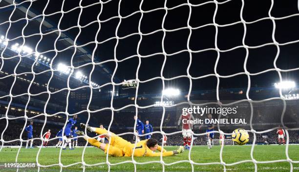 Chelsea's Spanish goalkeeper Kepa Arrizabalaga dives but fails to save a shot from Arsenal's Spanish defender Hector Bellerin, to score Arsenal's...