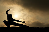 Martial Arts Male Silhouette on Dramatic Sky Background