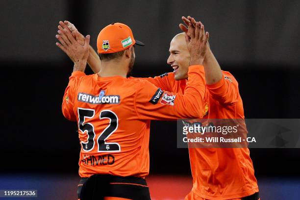 Ashton Agar of the Scorchers celebrates after taking the wicket of Tom Cooper of the Renegades during the Big Bash League match between the Perth...