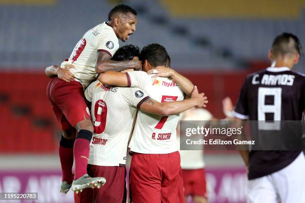 Jonathan Dos Santos of Universitario celebrates with teammates after scoring the first goal of his team during a match between Carabobo and...