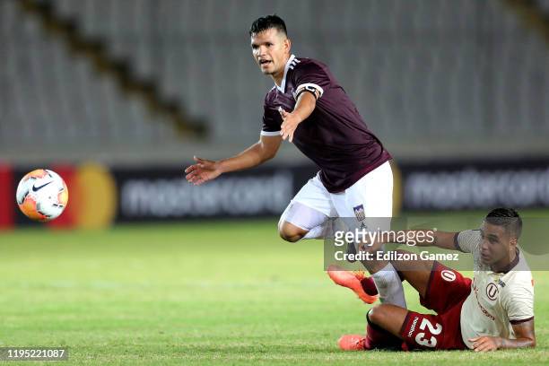 Luis Melo of Carabobo competes for the ball with Jesús Barco during a match between Carabobo and Universitario as part of the first stage of Copa...