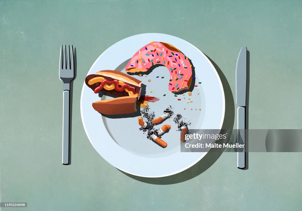 Half-eaten hot dog, donut and cigarette butts on plate