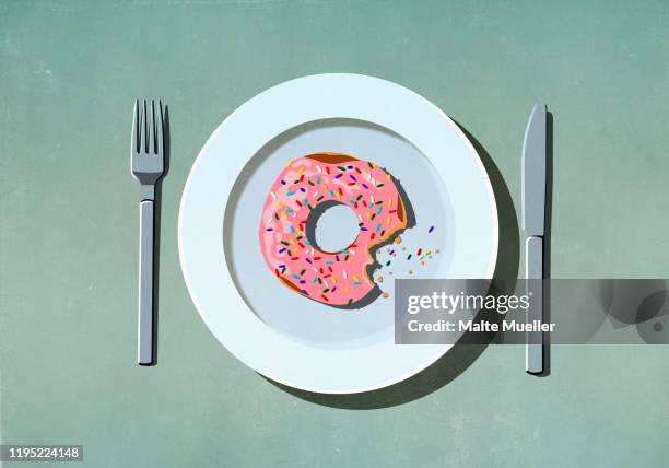 missing bite from pink donut with sprinkles on plate - comfort food stock illustrations