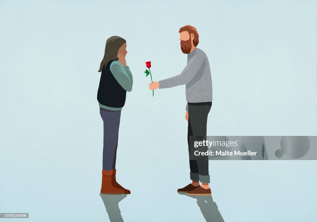 Man giving rose to surprised girlfriend