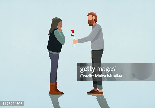 Man giving rose to surprised girlfriend Man giving rose to surprised girlfriend