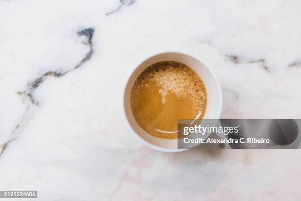 view from above espresso in mug on marble surface - color crema stockfoto's en -beelden