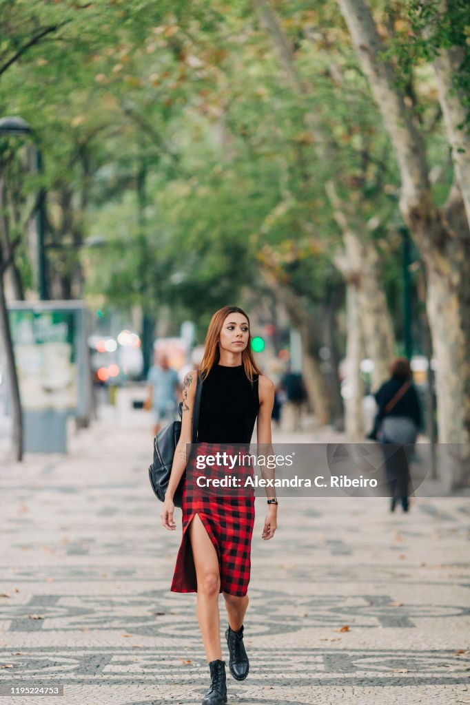 Stylish young woman walking in urban park